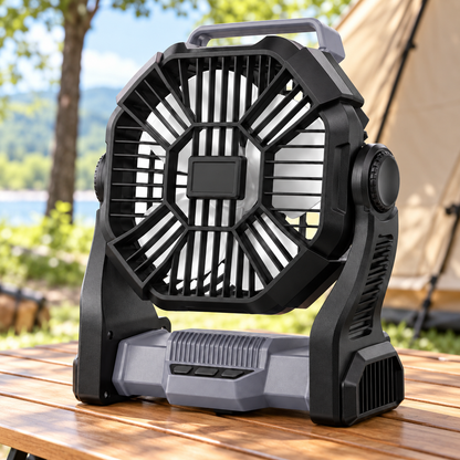 Gray and black portable camping fan on an outdoor table by a tent
